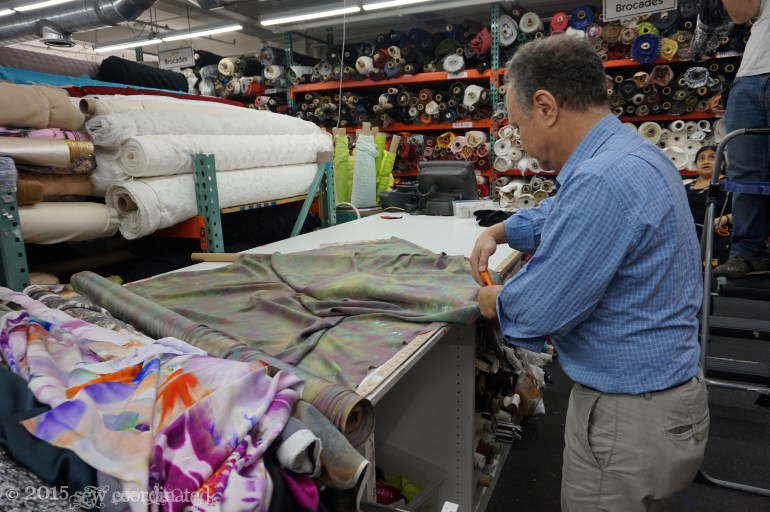 The man at the cutting table.